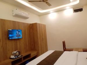 a bedroom with a bed and a air conditioner on the wall at Hotel Pushkar Town in Pushkar +45 photos