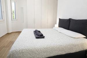 a bed with a pair of shoes sitting on it at Comfortable 1-Bedroom Central Menton in Menton
