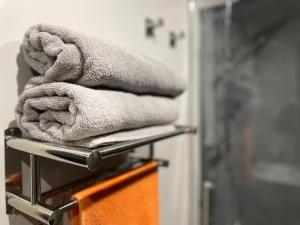 a pile of towels on a towel rack in a bathroom at Quarrymen's Arms in Nant-y-bwch +26 photos
