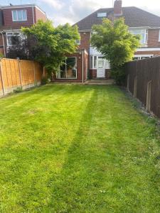a yard with a fence and a house at Parkfield House in Smethwick