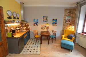 a kitchen with a sink and a table and chairs at Green Tree Apartment in Pécs