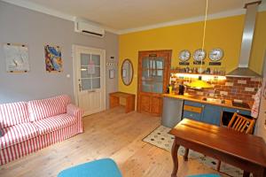 a living room with a couch and a table at Green Tree Apartment in Pécs +12 photos