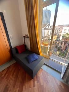 a couch in a room with a large window at Parthenope b&b in Naples
