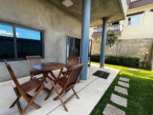 a wooden table and two chairs on a patio at A quiet corner in Cotonou in Cotonou