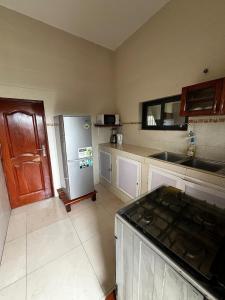 a kitchen with a refrigerator and a counter top at A quiet corner in Cotonou in Cotonou