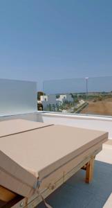 a table in a room with a large window at Seapalm Villa - Elegant Stay - Steps from the Sea in Lachania
