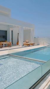 a swimming pool with blue water in a house at Seapalm Villa - Elegant Stay - Steps from the Sea in Lachania