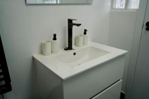 a bathroom sink with three rolls of toilet paper on it at Apartamentos Campus Arzúa in Arzúa +17 photos