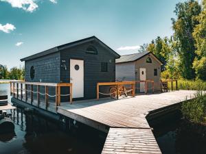 a building on a dock next to a body of water at Kelluva Jokimaja in Turenki