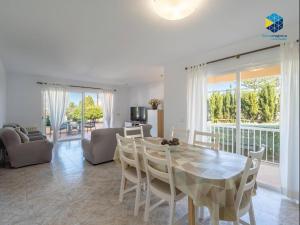 a living room with a dining room table and chairs at Can Moragues and Martorell in Badia Blava