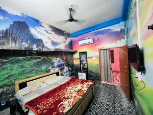 a bedroom with a painting on the wall at Oyo Royal Hotel & Janmasha in Rewa