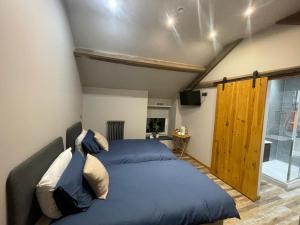a bedroom with a large bed and a window at Quarrymen's Arms in Nant-y-bwch