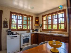 a kitchen with a table and a white stove top oven at Can Moreu in Caimari