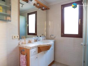 a bathroom with a sink and a mirror at Can Moreu in Caimari +30 photos