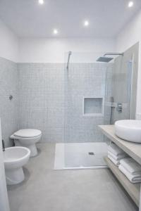 a bathroom with a toilet and a sink and a shower at Casa Schiattarella Napoli in Naples