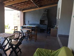 a living room with a table and chairs and a fireplace at Chacrinha in Campinas