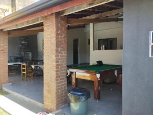a patio with a ping pong table in a house at Chacrinha in Campinas