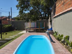 a swimming pool in a backyard with a playground at Chacrinha in Campinas