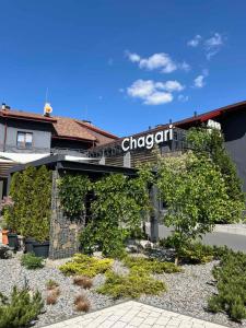 a building with a sign on the side of it at Chagari Hotel in Lypnyky