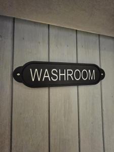 a sign that says washeny on a wall at Cotswold Cottage Guest House in Stow on the Wold