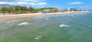 a group of people in the water at a beach at Tidal Mist Homestay in Long Hai