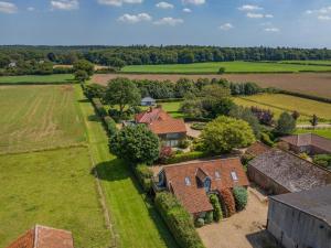 an aerial view of a house in a field at 1 Bed in Swannington oc-2206 in Attlebridge