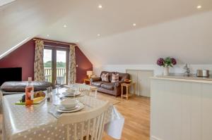 a living room with a table and a couch at 1 Bed in Swannington oc-2206 in Attlebridge