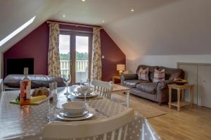 a living room with a table and a couch at 1 Bed in Swannington oc-2206 in Attlebridge