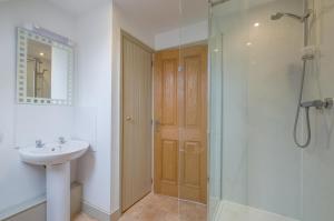 a bathroom with a sink and a shower with a glass door at 1 Bed in Swannington oc-2206 in Attlebridge +10 photos