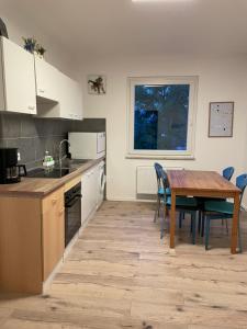 a kitchen with a wooden table and a table and chairs at City Wohnung in Haltern gratis Parken, Netflix & Wäschepaket in Haltern