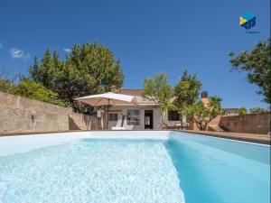 a swimming pool in front of a house at Ca sa comare in Llucmajor