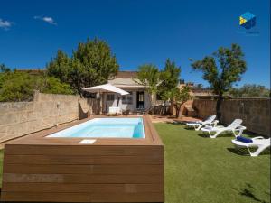 a swimming pool in the yard of a house at Ca sa comare in Llucmajor