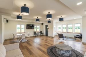 a living room with a table and chairs at Villa Asta in Rusnė