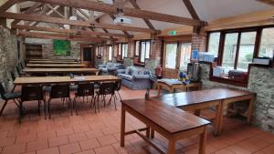 a large room with tables and chairs in a building at Magdalen The Old Dairy in Winsham