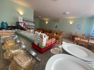 a restaurant with a counter with sinks in a room at Hostel Ferihegy in Vecsés