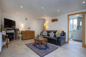 a living room with a couch and a coffee table at Bamford Barn in Ottery Saint Mary