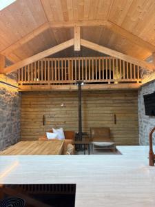 a living room with a wooden ceiling at Neds Barn in Galway