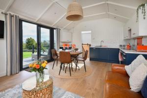 a kitchen and living room with a table and chairs at 2 Bed in Abererch oc-glwysf in Abererch