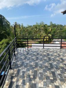 a balcony with a fence and a view of the ocean at Chandani Hostel in Galle