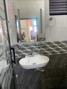a bathroom with a sink and a mirror at Chandani Hostel in Galle +1 photo
