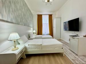 a hotel room with two beds and a television at Hotel Astoria, в самом центре города in Astana