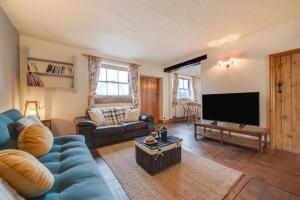 a living room with a blue couch and a tv at 2 Bed in Heacham oc-2365 in Heacham