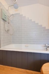 a bathroom with a shower and a bath tub at 2 Bed in Heacham oc-2365 in Heacham +8 photos