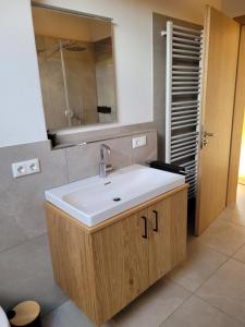 a bathroom with a sink and a mirror at Urlaub in Benediktbeuern in Benediktbeuern +10 photos