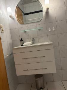 a bathroom with a sink and a mirror at Apartments Schnepel in Sankt Michaelisdonn +14 photos