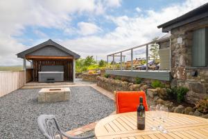 an outdoor patio with a table and a fireplace at 3 Bed in Trawsfynydd oc-wag718 in Trawsfynydd