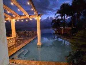 a swimming pool on a house with a view at Exotic Paradise Guest House in Yabucoa