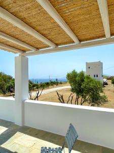 a view of the beach from the balcony of a house at Iosub Houses & Studios - Beach House in Koumbara in Tzamaria