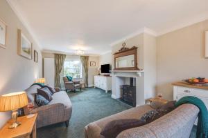 a living room with two couches and a fireplace at 3 Bed in Holt oc-2280 in Holt