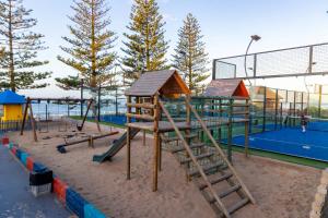 a playground with a slide and a ladder in the sand at Harbour House Mossel Bay - near sea & activities in Mossel Bay